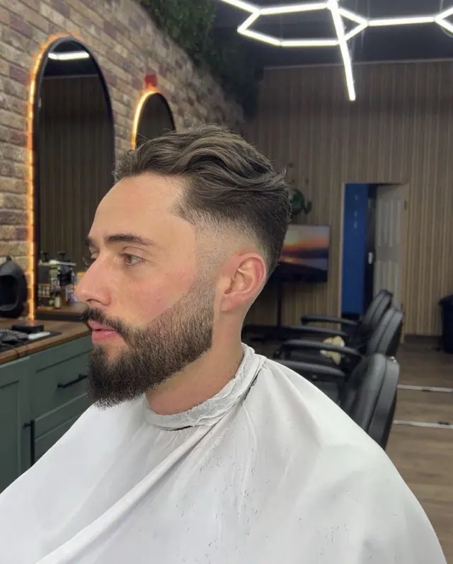A cut in progress at The Rock Barbers